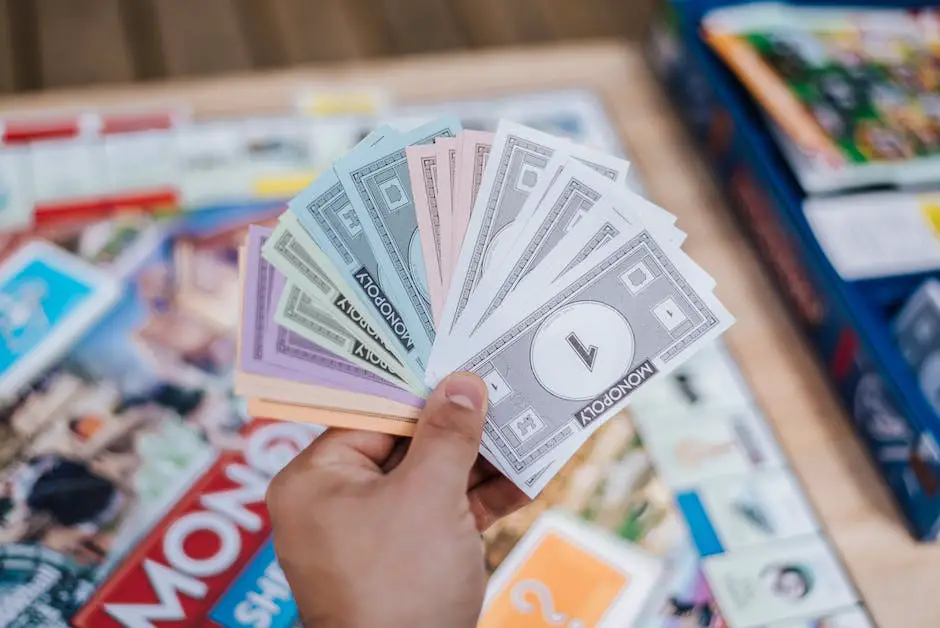 A picture of hands holding monopoly money, with board pieces and dice in the background.