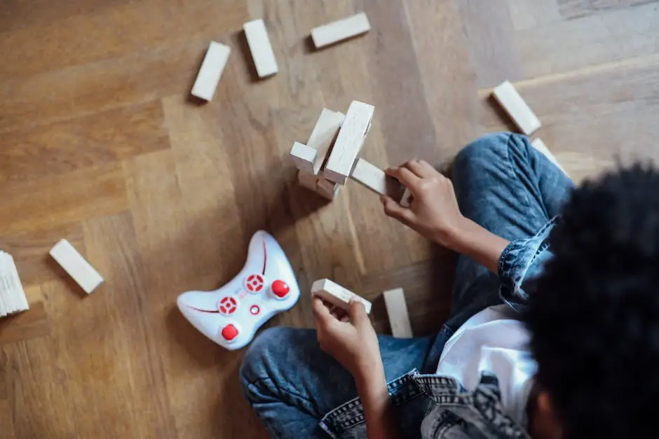 A tower of Jenga blocks, each one smaller than the previous, setup for the game with someone's hands in the background holding a block that they are about to remove