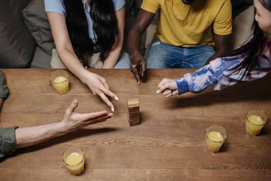 A group of people playing Bananagrams on a table, with tiles forming a word grid in the center.