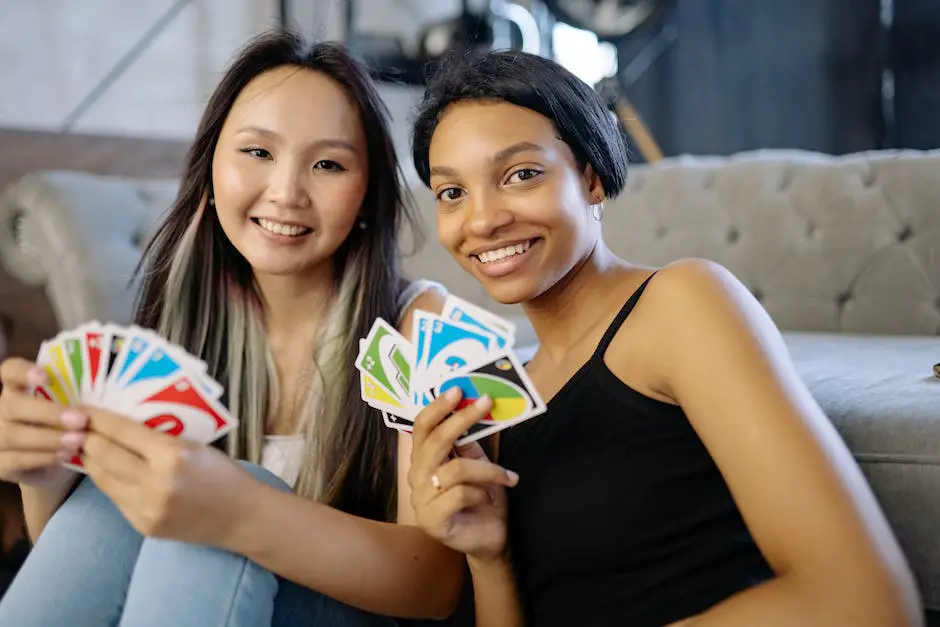 Five friends sitting around a table playing a card game with a deck of cards.