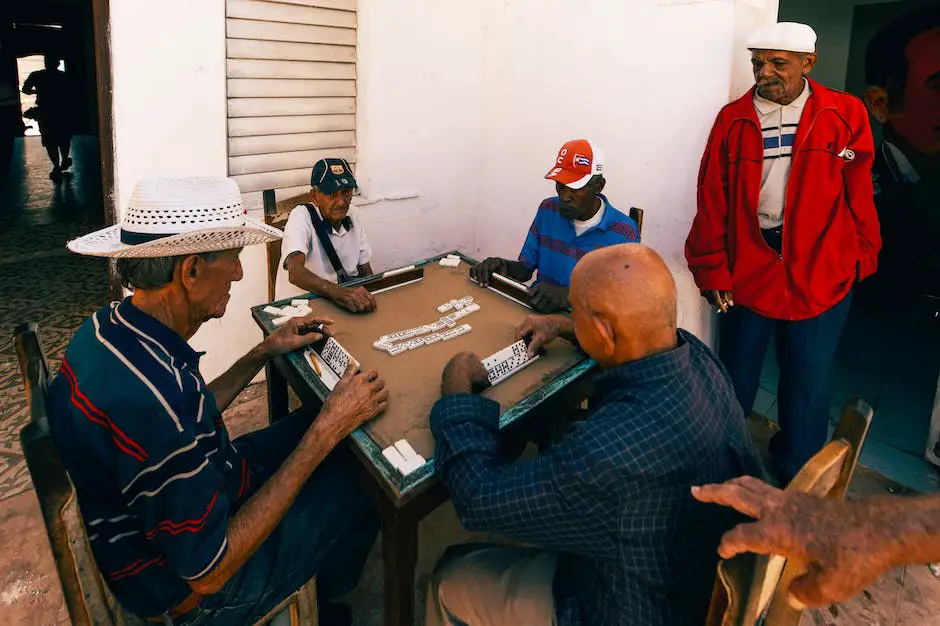 Two men sitting at a table playing a board game, with a die tower in the background.