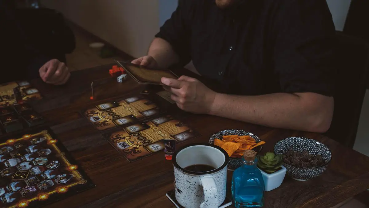 Image of people playing Pandemic board game, gathered around a table, strategizing and having fun.