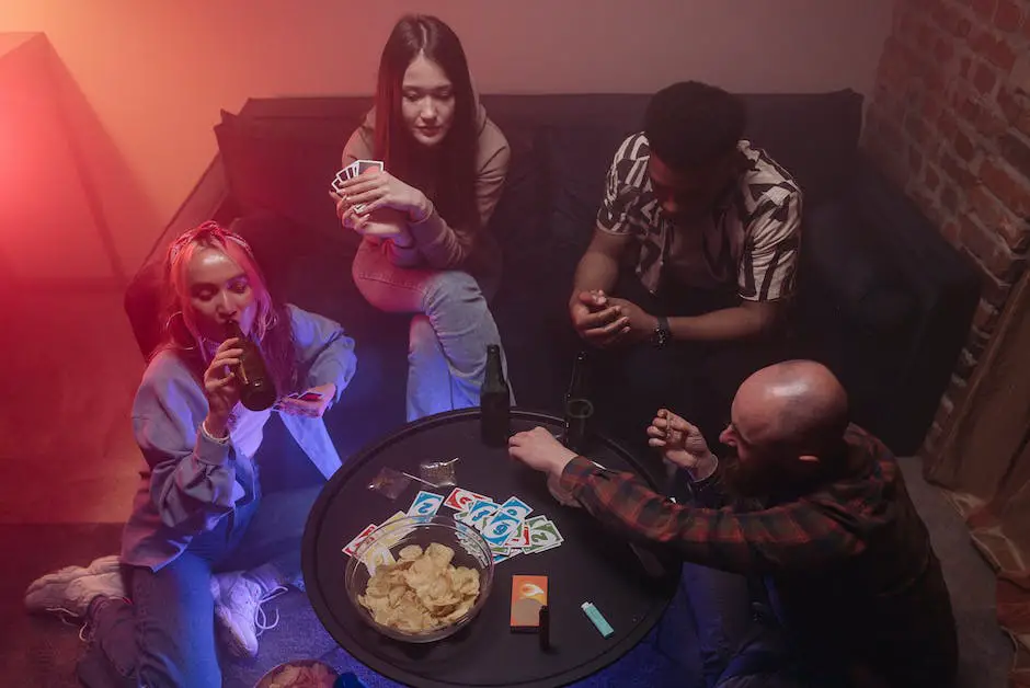 A group of people sitting around a table playing Pitch, with cards spread out on the table.