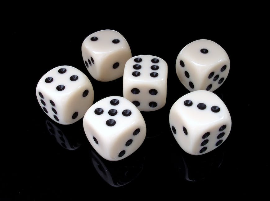 A group of people playing Yahtzee, with one player looking at their dice intently while the others watch with interest.